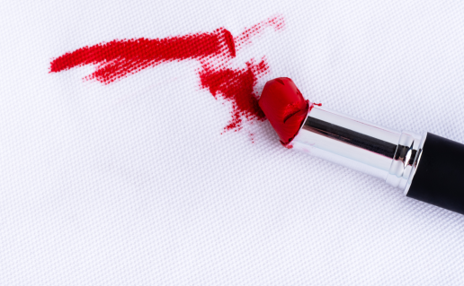 Red lipstick smeared on white fabric