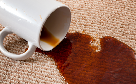 White mug spilling coffee on carpet