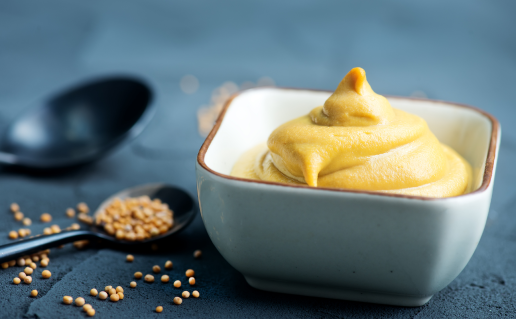 Small, white square bowl of mustard