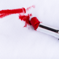 Red lipstick smeared on white fabric